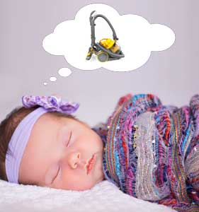 sleeping baby with a vacuum cleaner